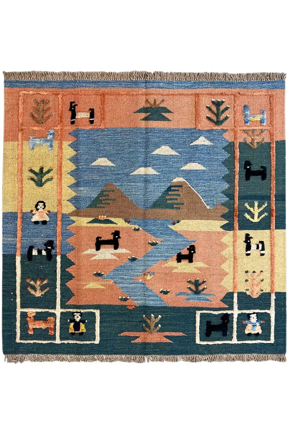 Tapis Kilim à motif central géométrique, bordure encadrée bleue et brun rouille, franges