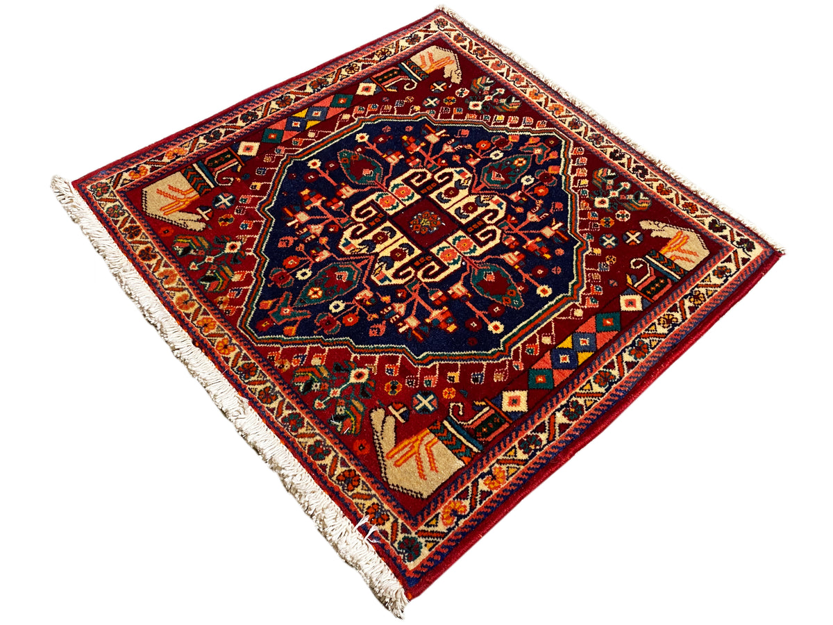 Tapis Poshti 64x64 cm, carré, motif diagonal, médaillon bleu foncé, détails colorés, franges