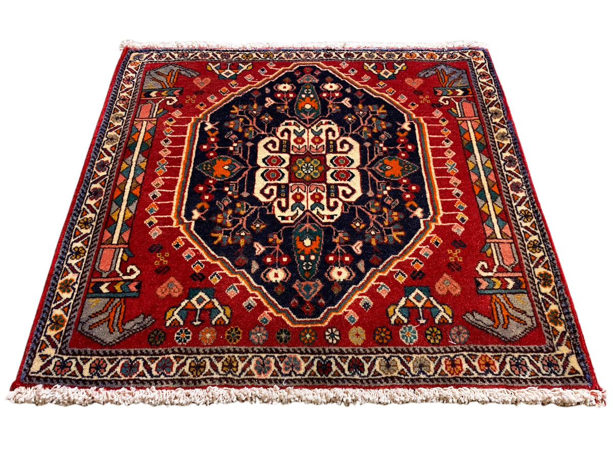 Tapis à fond rouge, médaillon bleu foncé, ornement symétrique, rectangulaire
