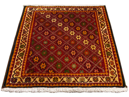 Tapis Poshti rectangulaire, multicolore, avec bordure décorative et franges sur les bords.